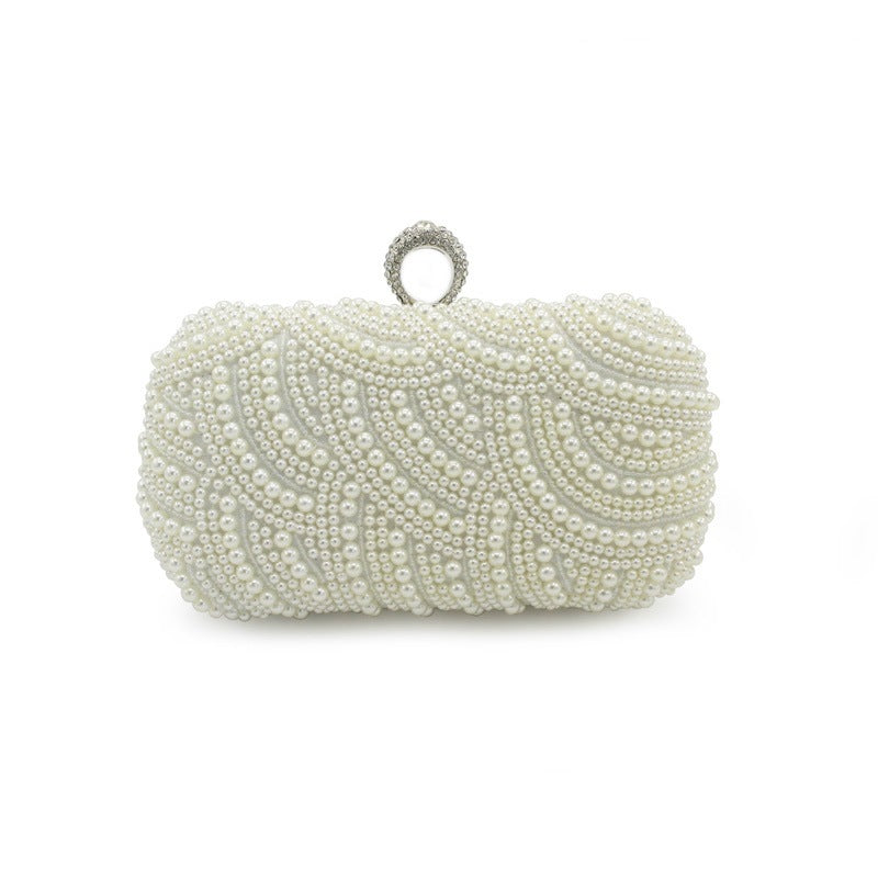 Rhinestone and Pearl Ringed Banquet Clutch Bag. Fully studded with pearls all over. The top clasp is adorned with a rhinestone ring to slip most fingers through as an extra way to securely hold your clutch bag. 7.48 inches in imperial measurements in length.  Comes in white and beige.