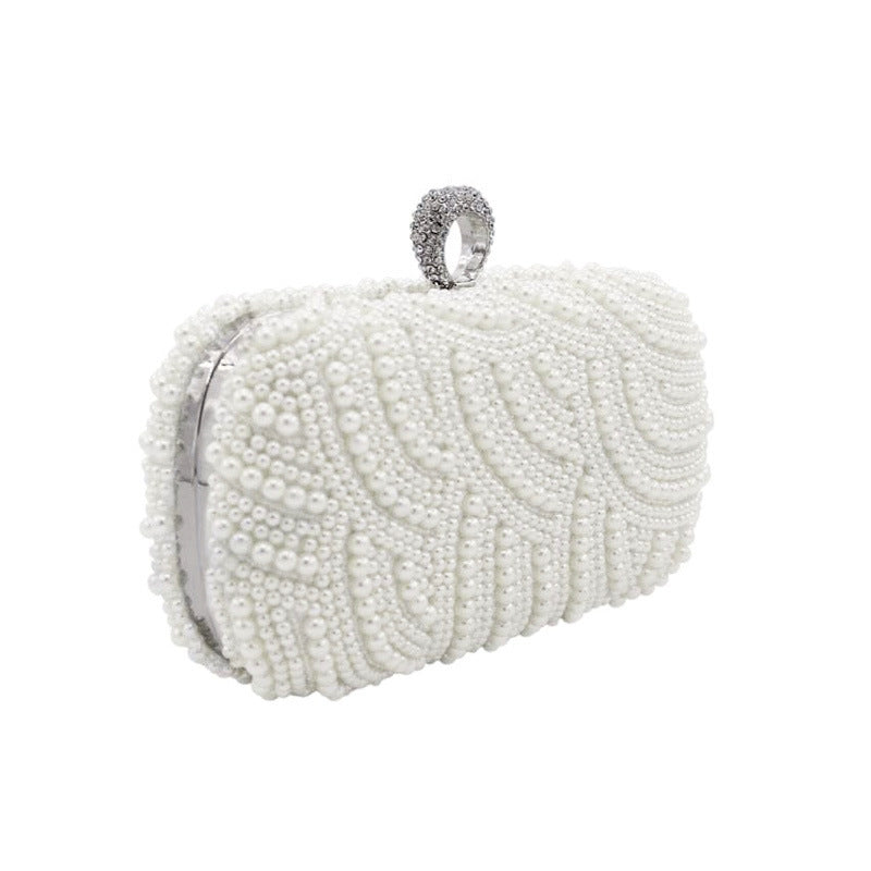 Rhinestone and Pearl Ringed Banquet Clutch Bag. Fully studded with pearls all over. The top clasp is adorned with a rhinestone ring to slip most fingers through as an extra way to securely hold your clutch bag.  Comes in 2 colors.  Beige and white.
